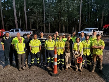 A group of workers standing together and smiling
